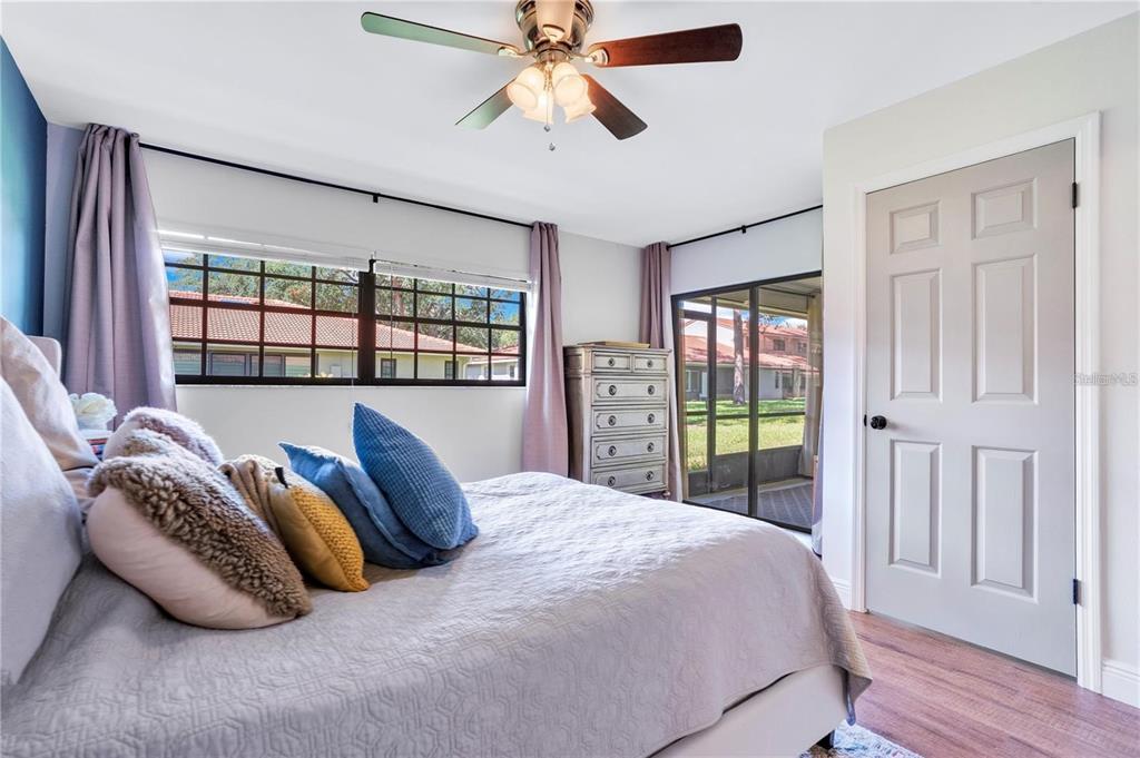 7736 Windbreak Road Orlando, FL 32819 - Photo 19 of 43 a bedroom with a bed and a large window