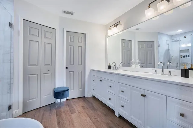 a spacious bathroom with a granite countertop sink mirror and toilet