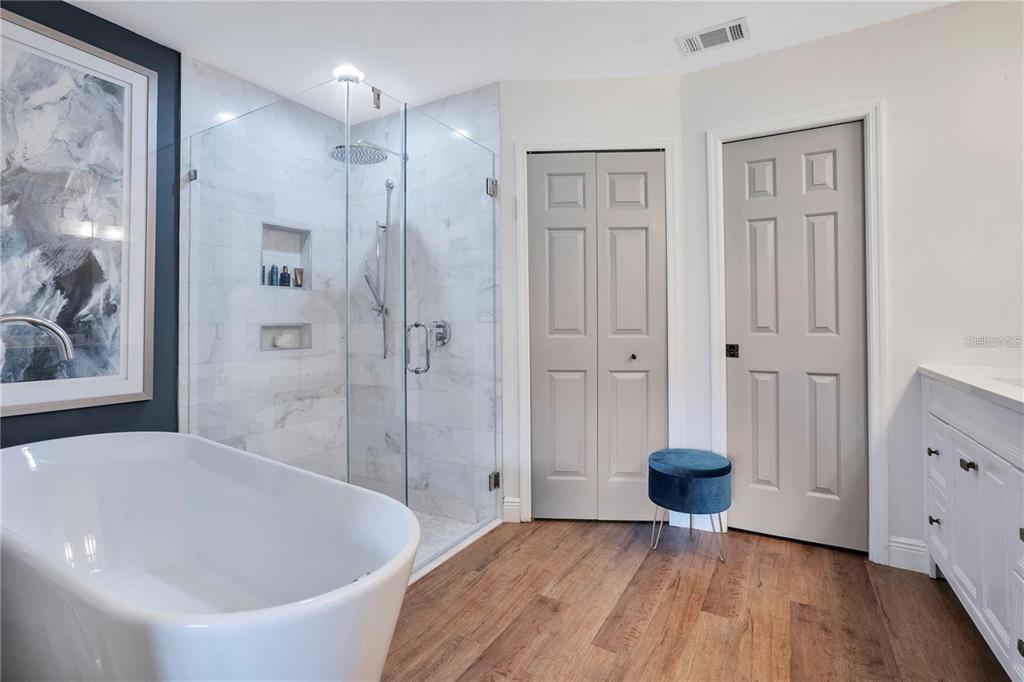 7736 Windbreak Road Orlando, FL 32819 - Photo 22 of 43 a bathroom with a bathtub and a shower