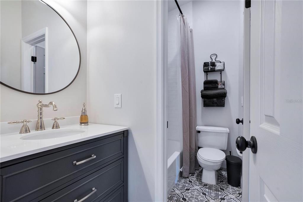 7736 Windbreak Road Orlando, FL 32819 - Photo 27 of 43 a bathroom with a toilet sink and mirror