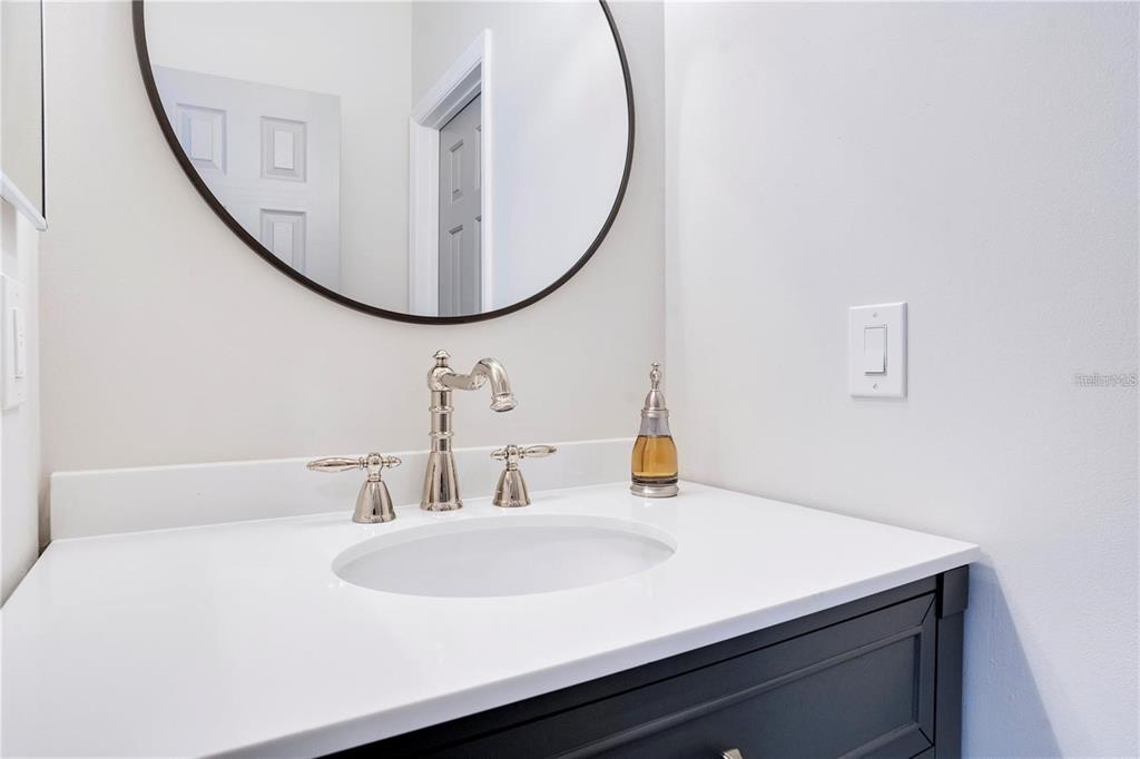 7736 Windbreak Road Orlando, FL 32819 - Photo 28 of 43 a bathroom with a sink and a mirror