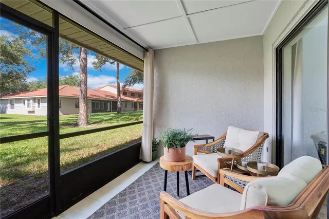 a living room with furniture and a floor to ceiling window