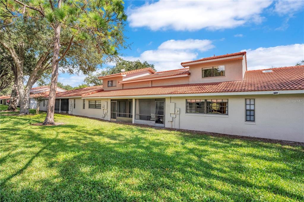 7736 Windbreak Road Orlando, FL 32819 - Photo 33 of 43 a front view of a house with a garden