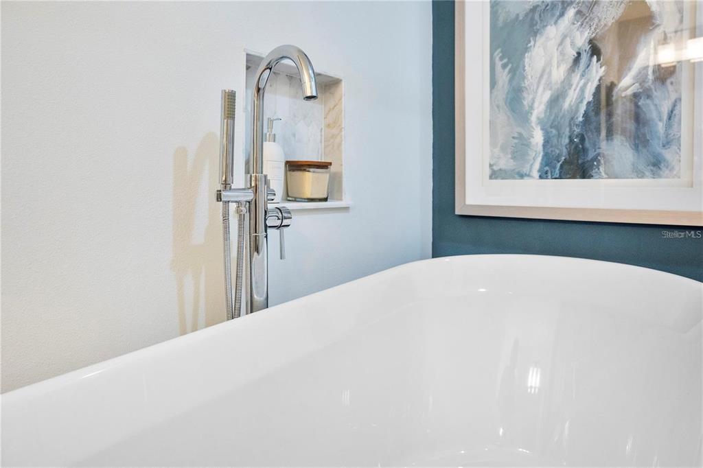 7736 Windbreak Road Orlando, FL 32819 - Photo 43 of 43 a bedroom with a bed and a painting on the wall