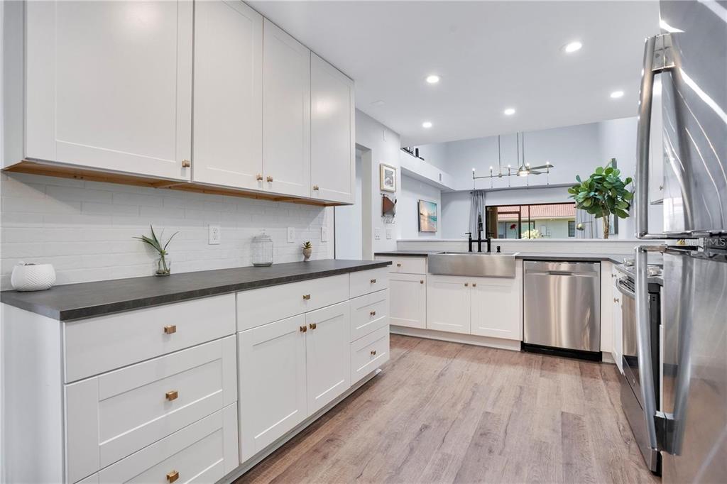 7736 Windbreak Road Orlando, FL 32819 - Photo 6 of 43 a kitchen with white cabinets and sink