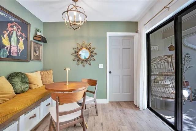 a view of a dining room with furniture wooden floor and a chandelier