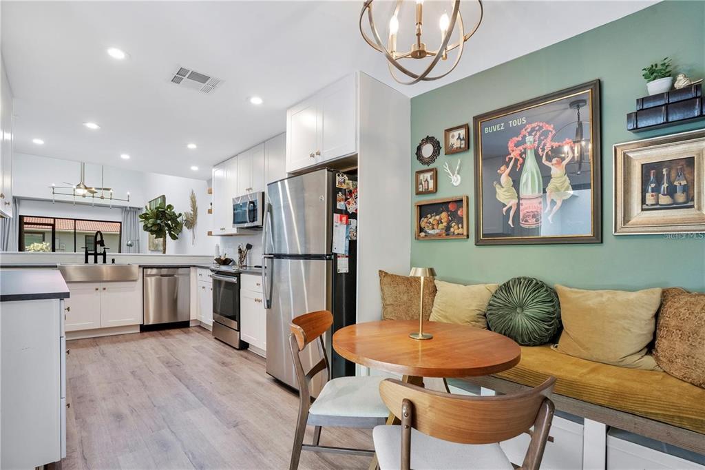 7736 Windbreak Road Orlando, FL 32819 - Photo 8 of 43 a living room with stainless steel appliances furniture and a kitchen view