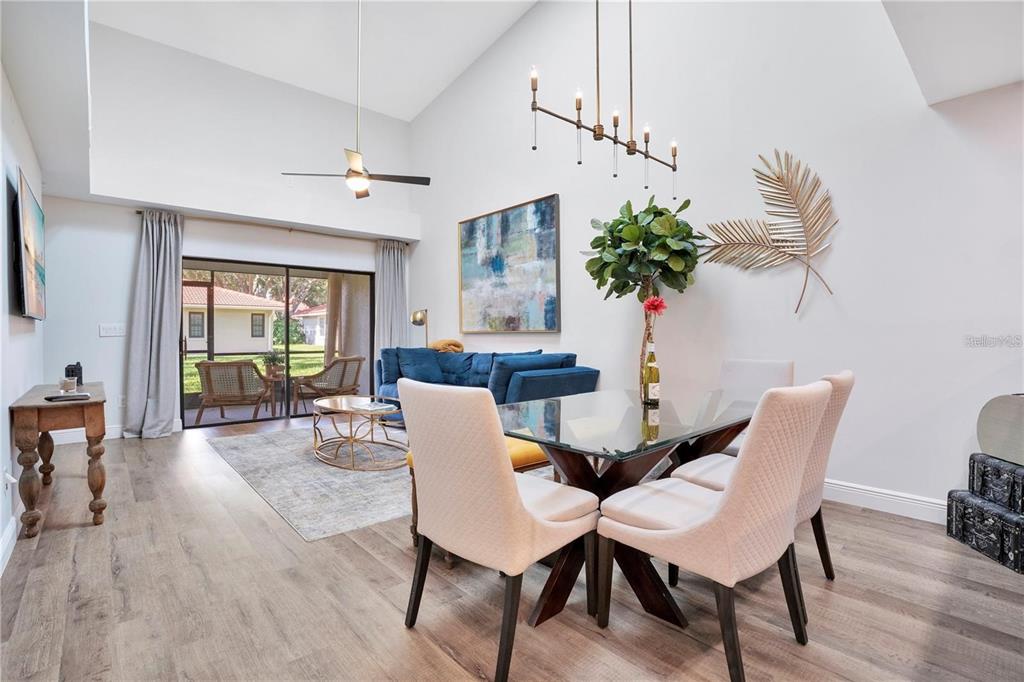 7736 Windbreak Road Orlando, FL 32819 - Photo 9 of 43 a dining room with furniture potted plants and wooden floor