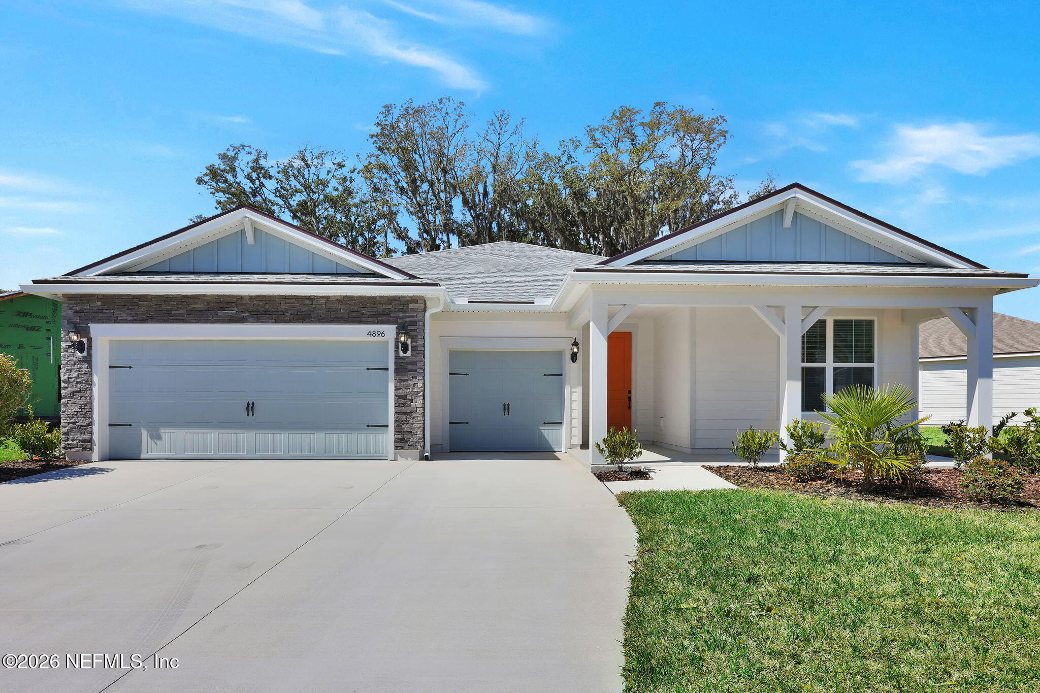 4896 Shell Crk Trail Jacksonville, FL 32226 - Photo 1 of 27 a front view of a house with a yard and garage