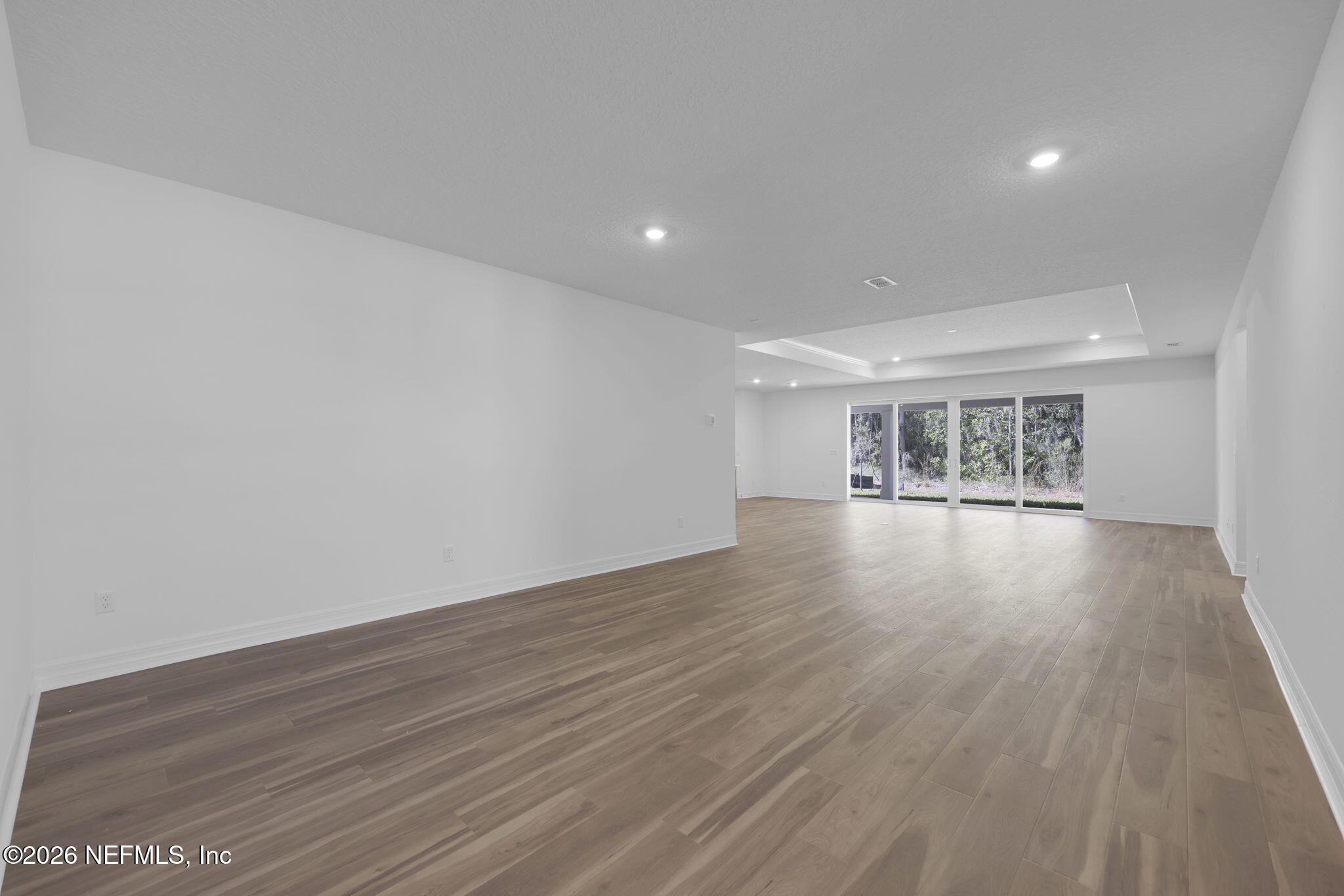 4896 Shell Crk Trail Jacksonville, FL 32226 - Photo 11 of 27 a view of an empty room with wooden floor and a window