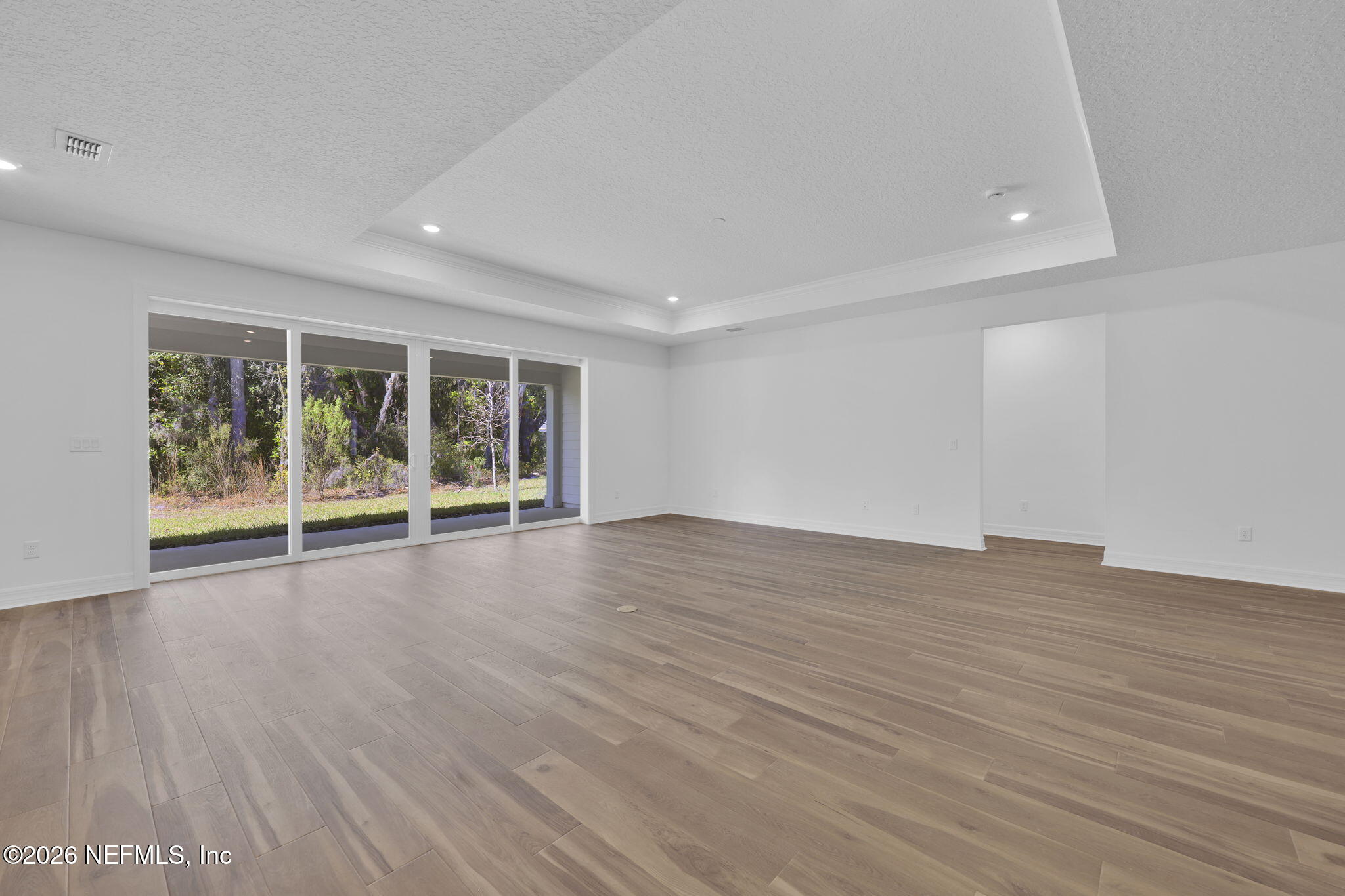 4896 Shell Crk Trail Jacksonville, FL 32226 - Photo 16 of 27 wooden floor in an empty room with a window