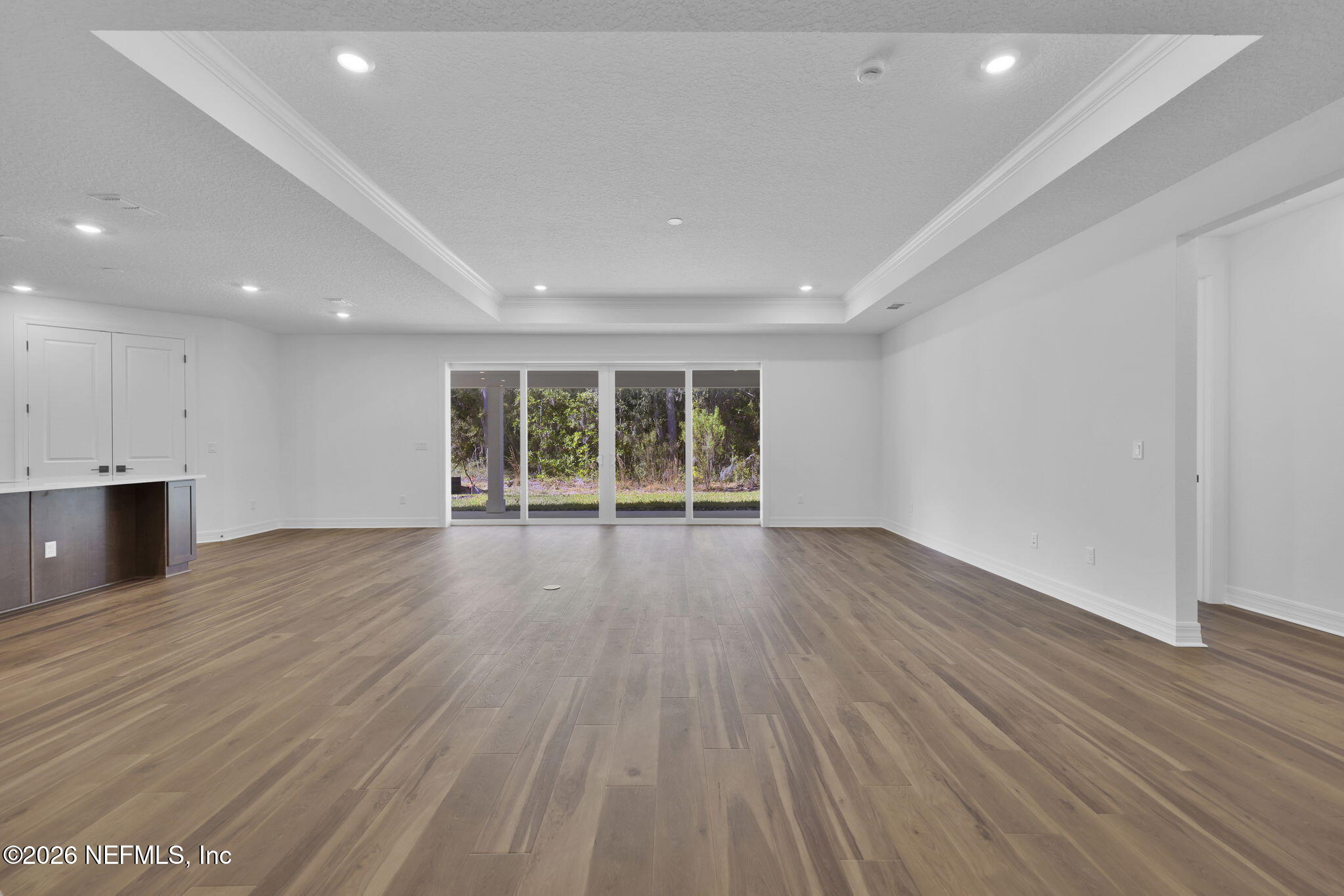 4896 Shell Crk Trail Jacksonville, FL 32226 - Photo 17 of 27 an empty room with wooden floor and windows