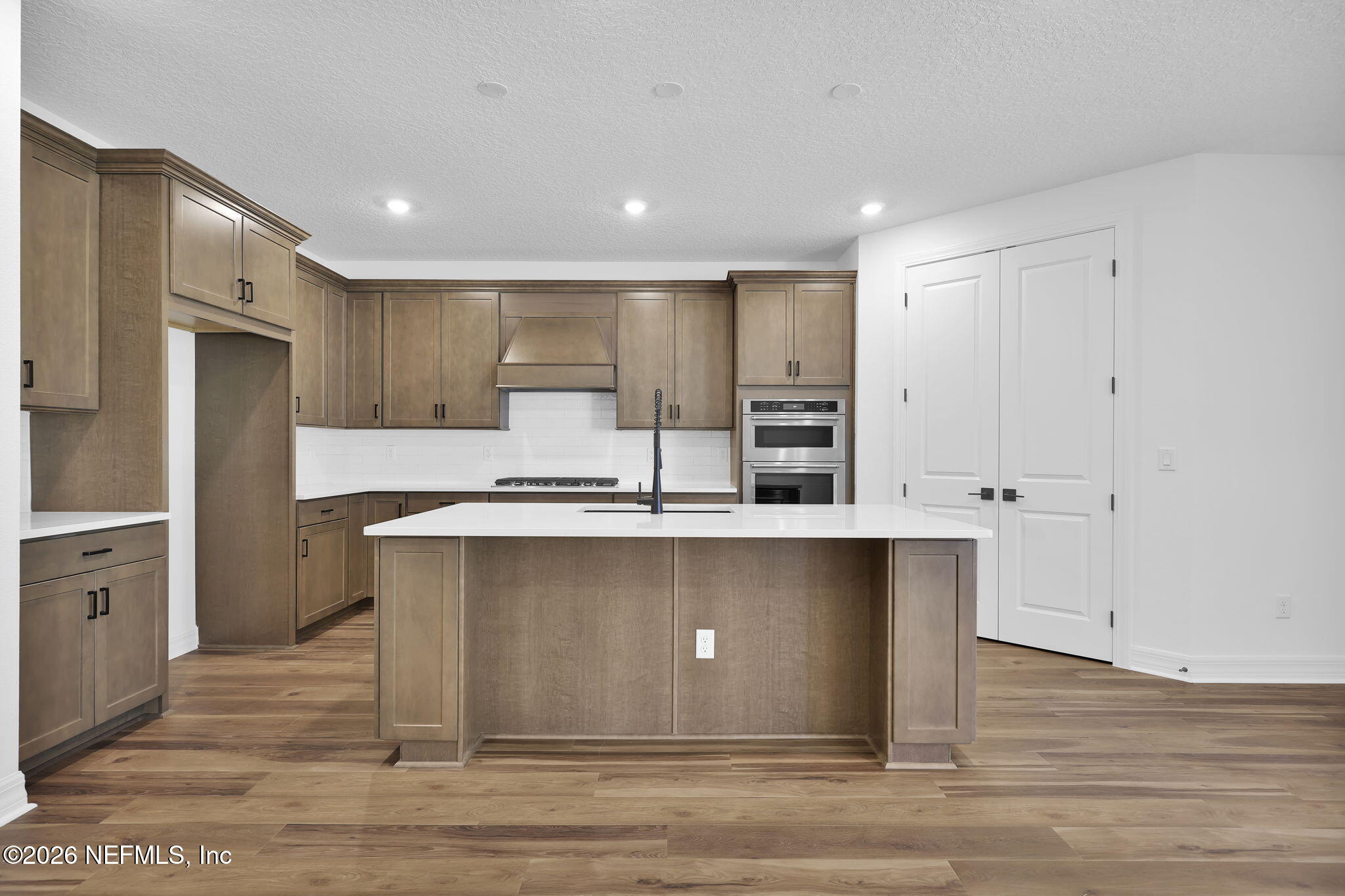 4896 Shell Crk Trail Jacksonville, FL 32226 - Photo 5 of 27 a kitchen with stainless steel appliances granite countertop a sink a stove a refrigerator and white cabinets