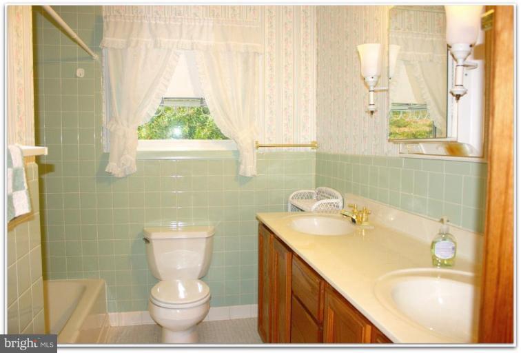 3115 Holland Cliffs Road Huntingtown, MD 20639 - Photo 11 of 13 a bathroom with a sink toilet and shower