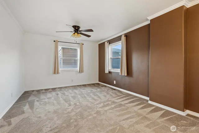 a view of a livingroom with a chandelier fan and a bathroom