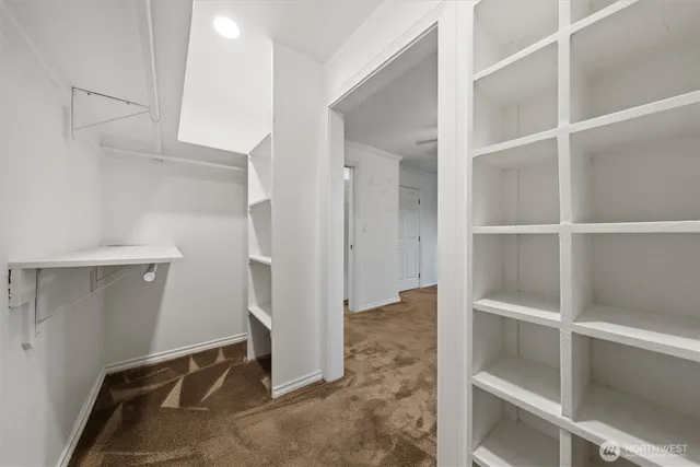 a view of a hallway to rooms and stairs