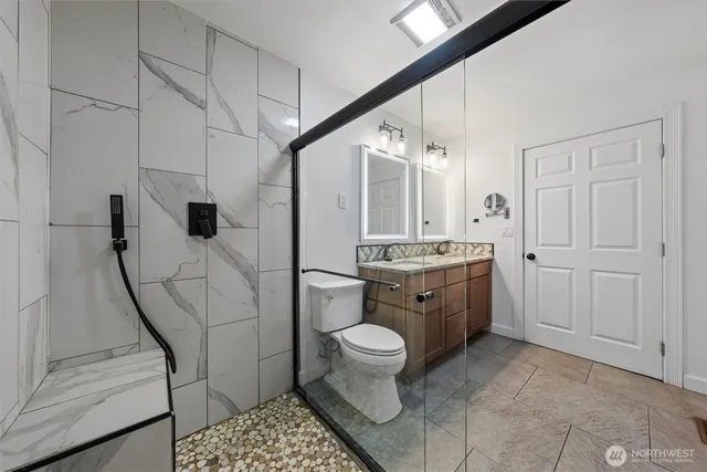 a bathroom with a granite countertop sink and a mirror