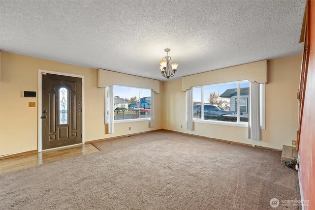 an empty room with painting and furniture