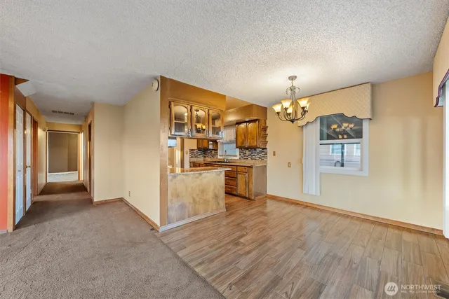 a kitchen with stainless steel appliances granite countertop a stove and a refrigerator