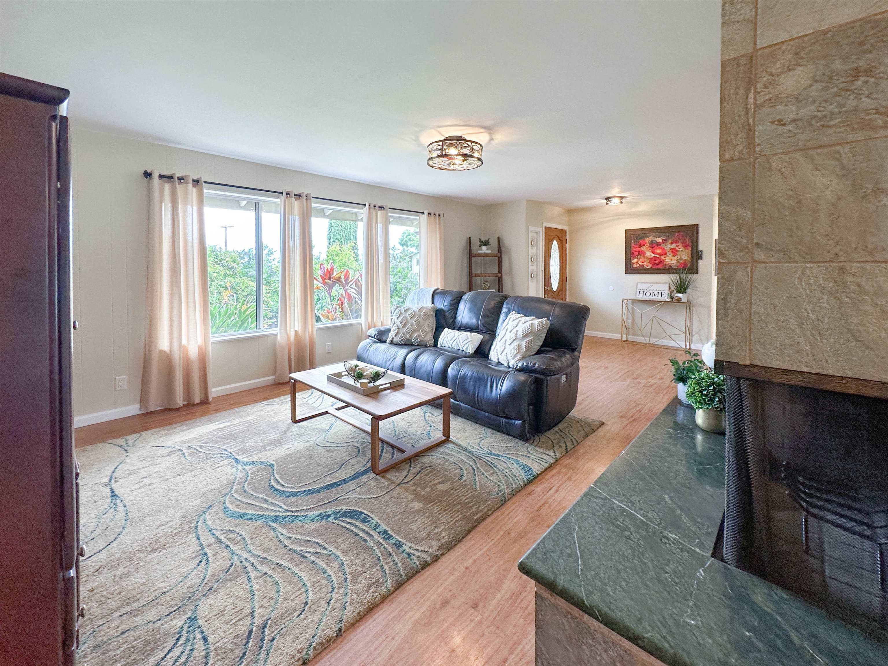 1875 Lower Kula Road Kula, HI 96790 - Photo 13 of 36 a living room with furniture and a fireplace