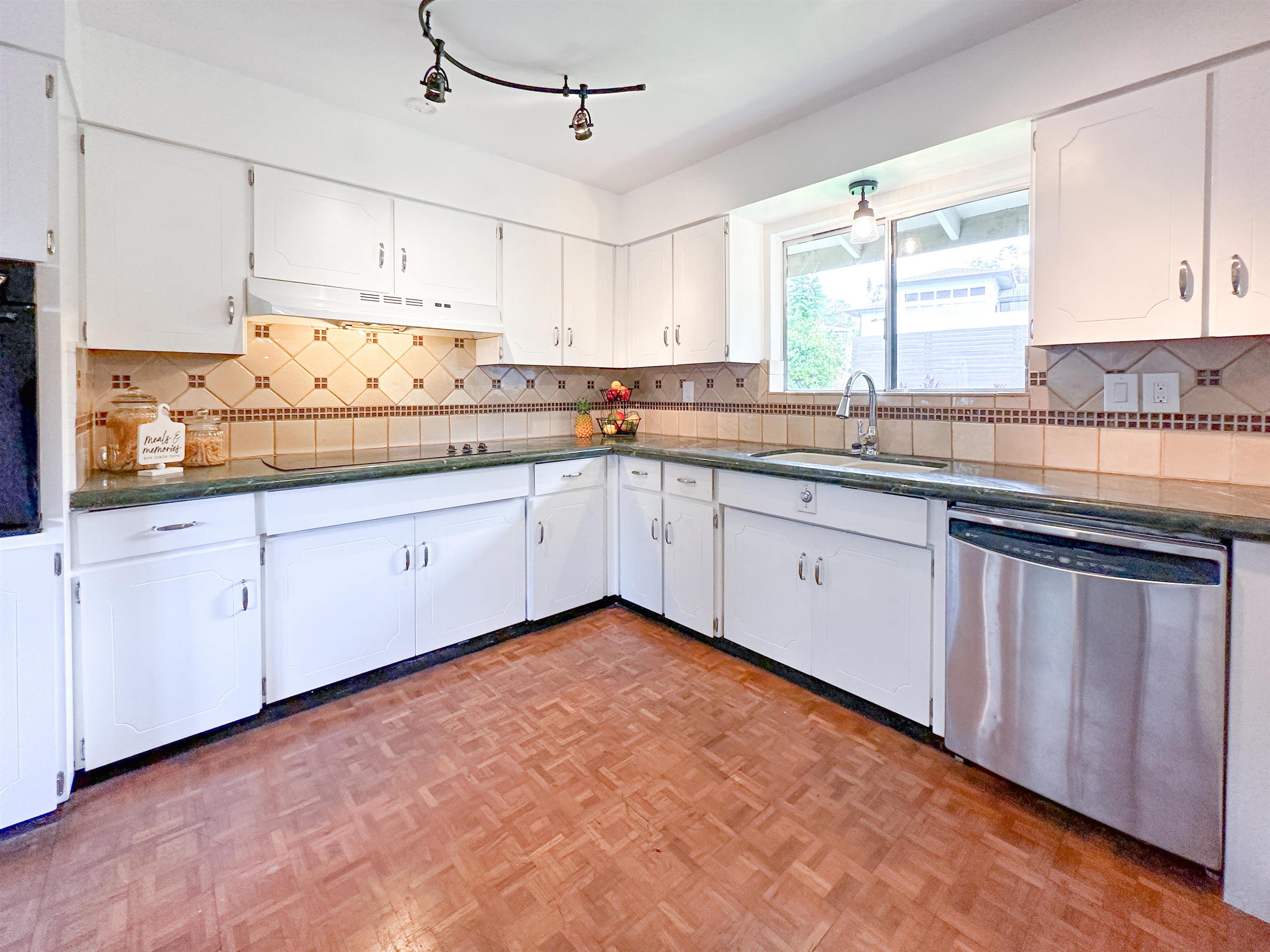 1875 Lower Kula Road Kula, HI 96790 - Photo 2 of 36 a kitchen with granite countertop white cabinets white appliances and sink