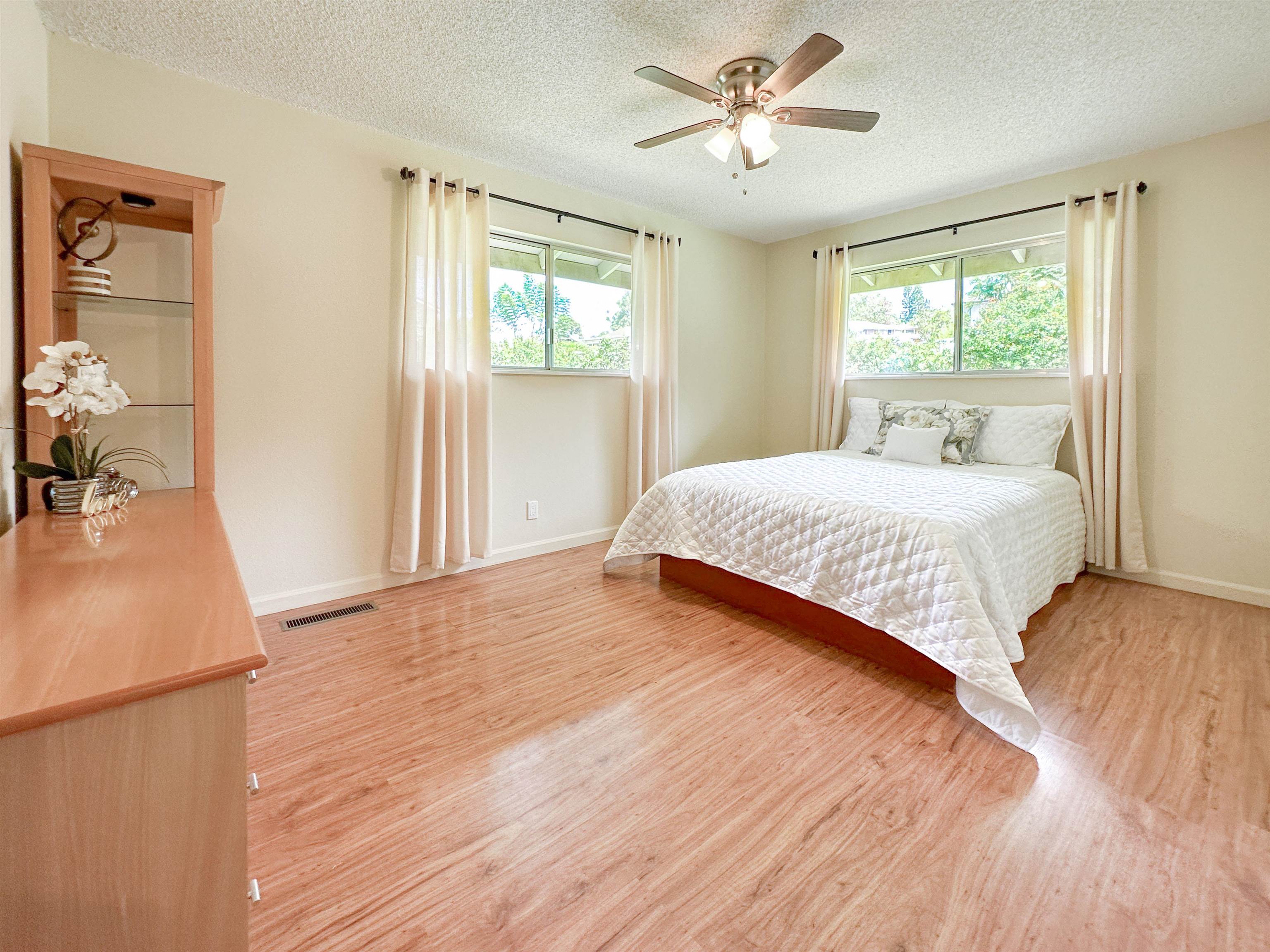 1875 Lower Kula Road Kula, HI 96790 - Photo 23 of 36 a bedroom with a large bed and a window