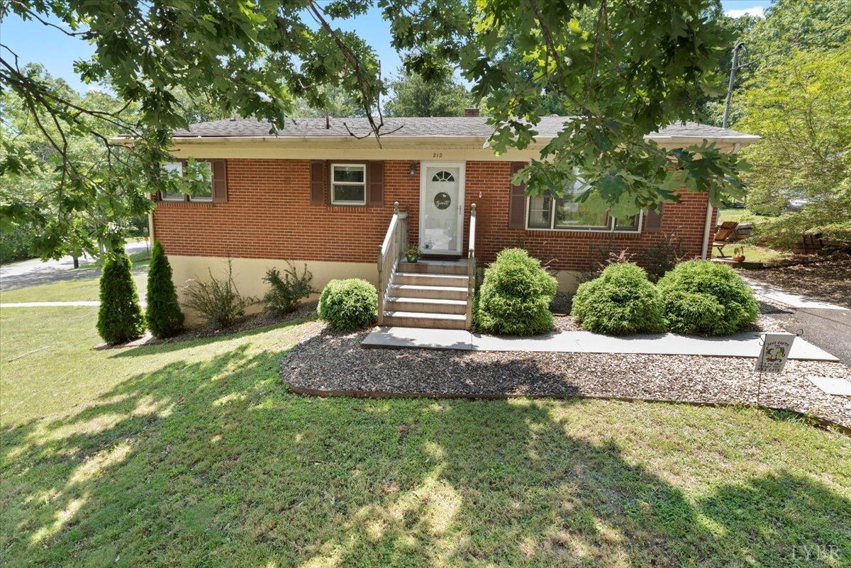 a front view of a house with a yard and a garage