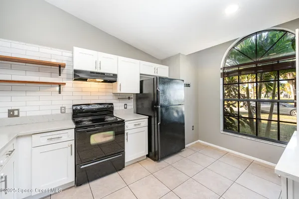 a kitchen with a stove a refrigerator and a sink