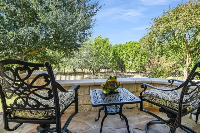 a view of a chairs and table in the patio