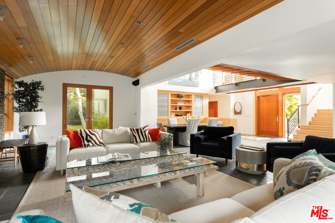 2244 Mandeville Canyon Road Los Angeles, CA 90049 - Photo 11 of 50 a living room with furniture and a large window