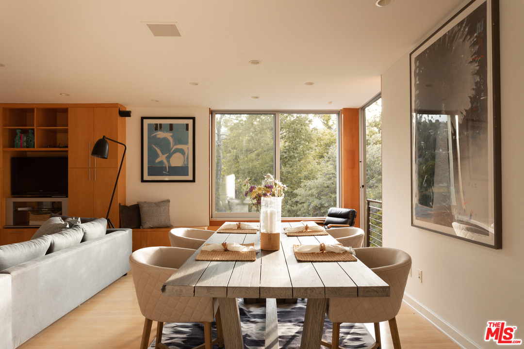 2244 Mandeville Canyon Road Los Angeles, CA 90049 - Photo 13 of 50 a view of a dining room with furniture window and outside view