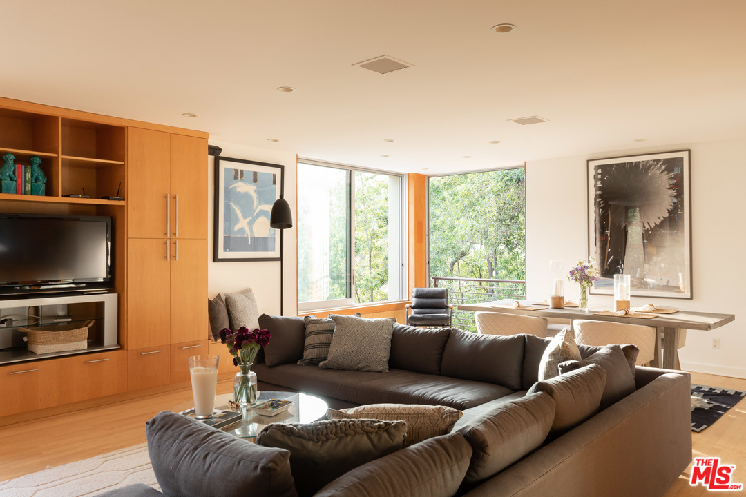 2244 Mandeville Canyon Road Los Angeles, CA 90049 - Photo 14 of 50 a living room with furniture a flat screen tv and a large window