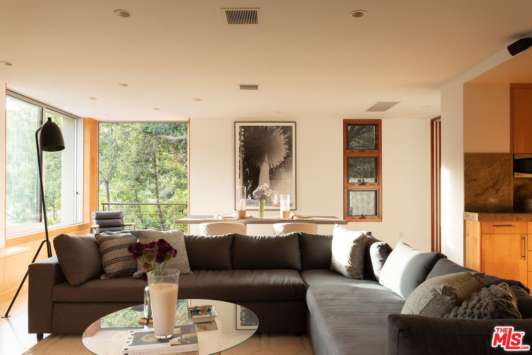2244 Mandeville Canyon Road Los Angeles, CA 90049 - Photo 15 of 50 a living room with furniture fireplace and a large window