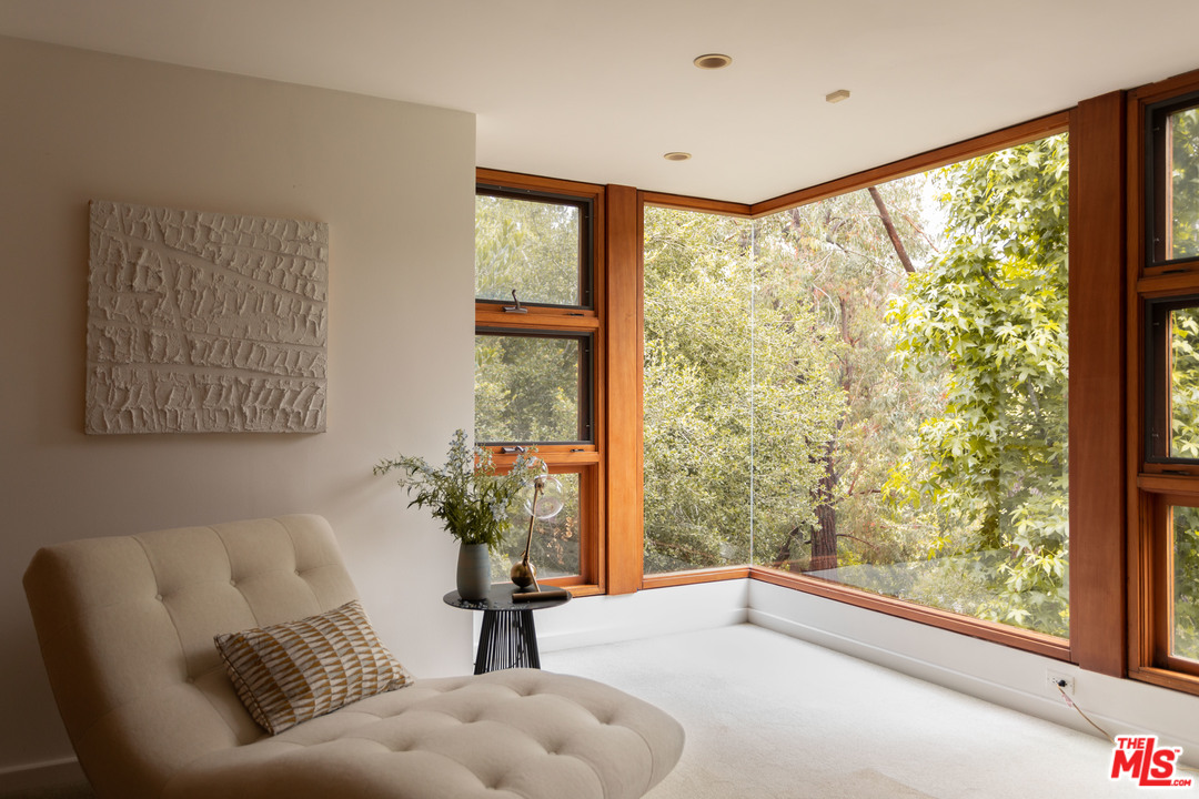 2244 Mandeville Canyon Road Los Angeles, CA 90049 - Photo 20 of 50 a living room with furniture and a large window
