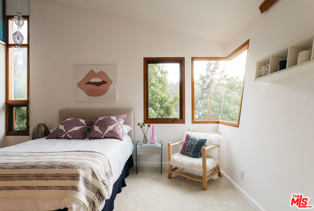 2244 Mandeville Canyon Road Los Angeles, CA 90049 - Photo 40 of 50 a bedroom with a bed and a couch