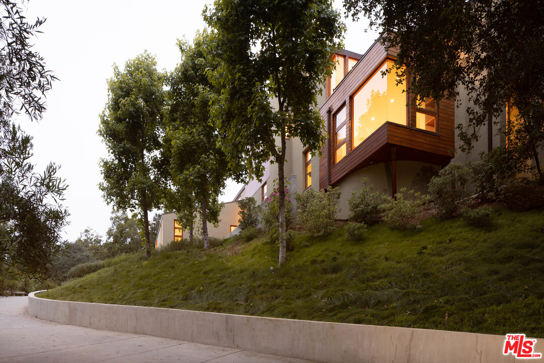 2244 Mandeville Canyon Road Los Angeles, CA 90049 - Photo 50 of 50 a view of a house with a yard