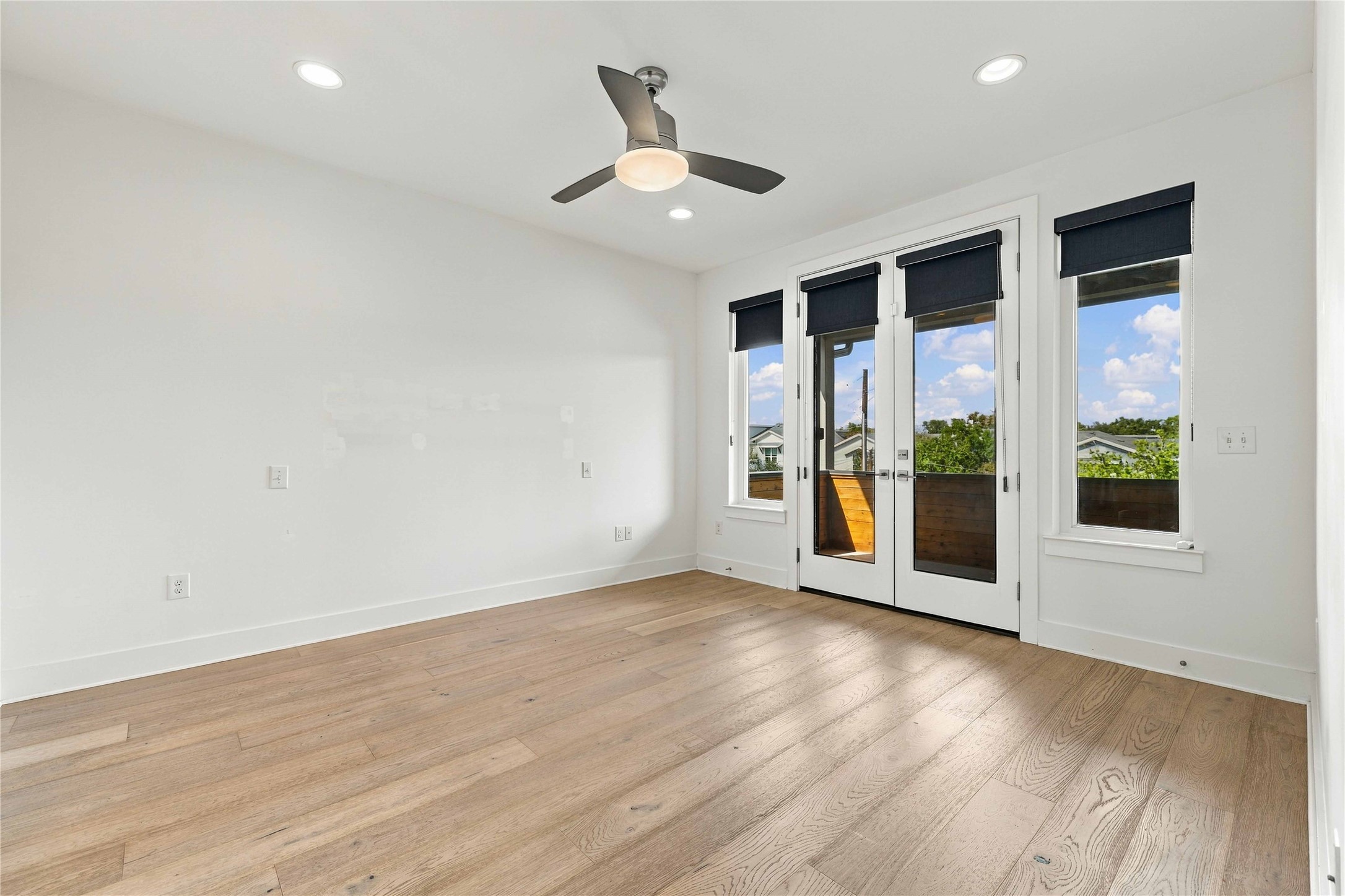 5006 Pecan Springs Road, Unit 7 Austin, TX 78723 - Photo 12 of 38 Gleaming hardwood floors and recessed lighting enhance this versatile bedroom space with balcony access.