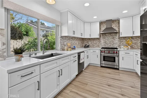 a kitchen with a refrigerator a sink and a stove