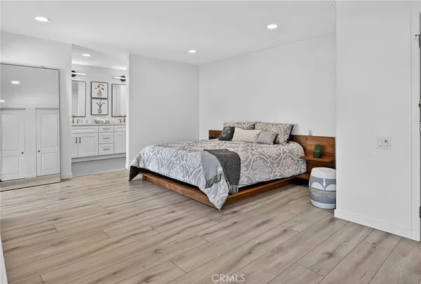 a bed room with a bed and a potted plant