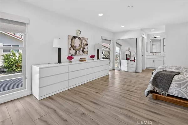 a bedroom with a bed and a potted plant
