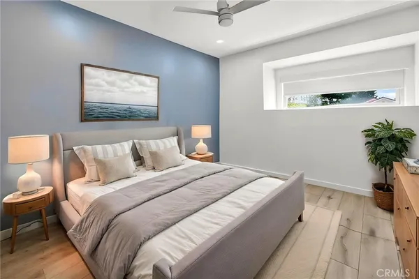 a bedroom with a bed and a painting on the wall