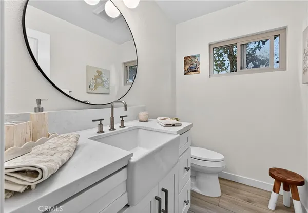 a living room with fireplace furniture flat screen tv and wooden floor