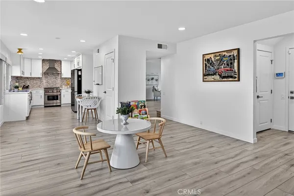 a large kitchen with stainless steel appliances granite countertop a stove a sink and a refrigerator