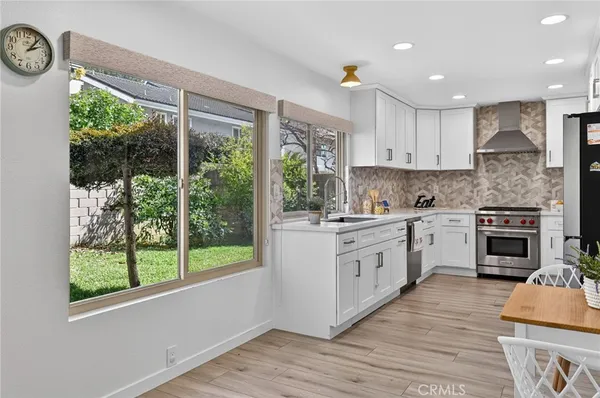a view of a hallway with wooden floor and workspace