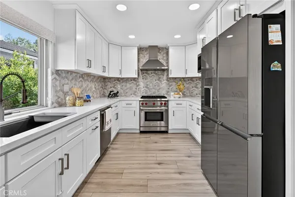 a view of a workspace with wooden floor and a window