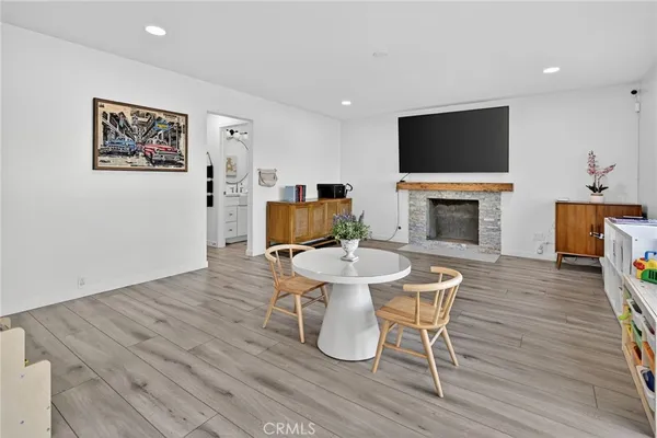 a living room with furniture a wooden floor and a large window