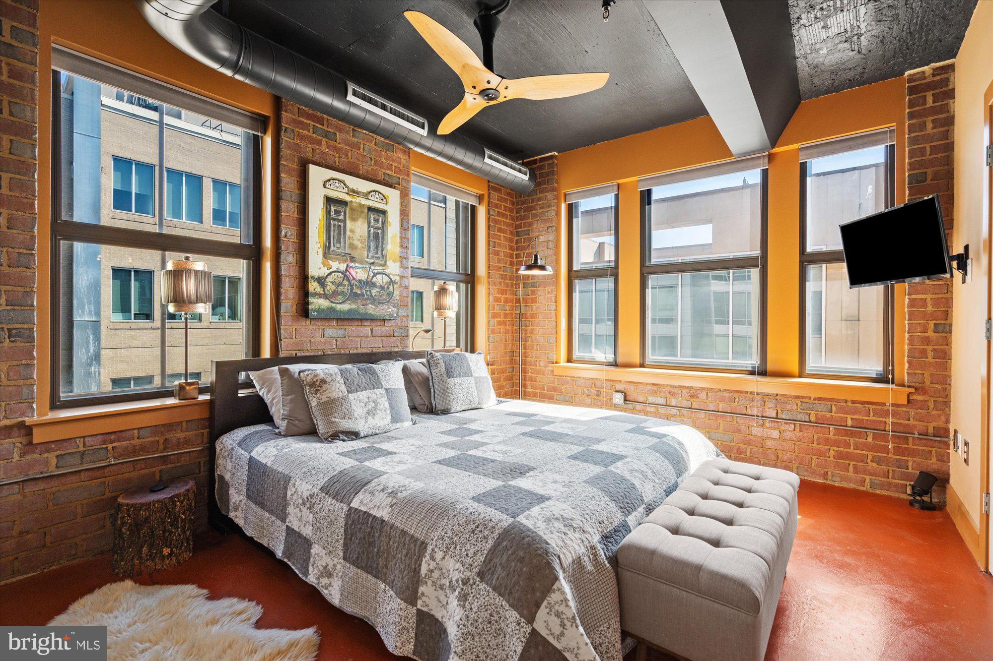 916 G St. Northwest, Unit 803 Washington, DC 20001 - Photo 15 of 27 a bedroom with a large bed and a large window