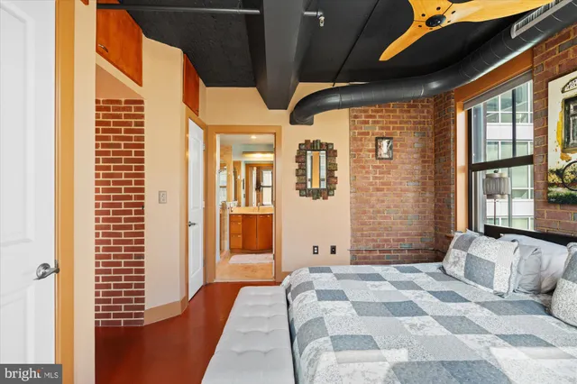a bedroom with furniture and large windows
