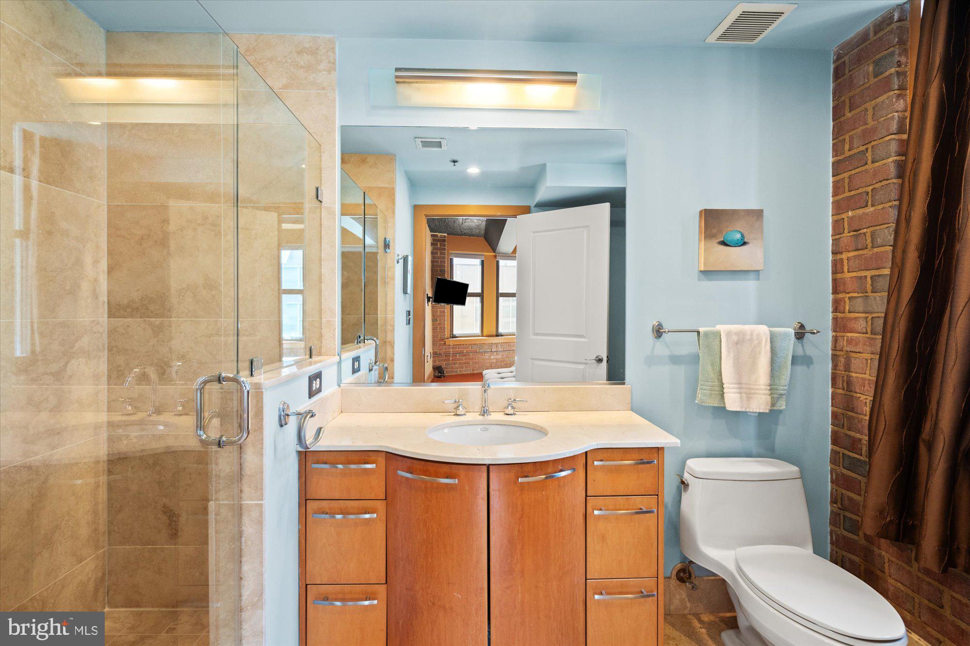916 G St. Northwest, Unit 803 Washington, DC 20001 - Photo 19 of 27 a bathroom with a sink a toilet and shower