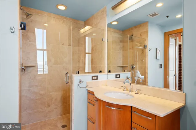 a bathroom with a sink double vanity and a mirror